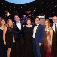 Guests posing in front of the Enrichment stage